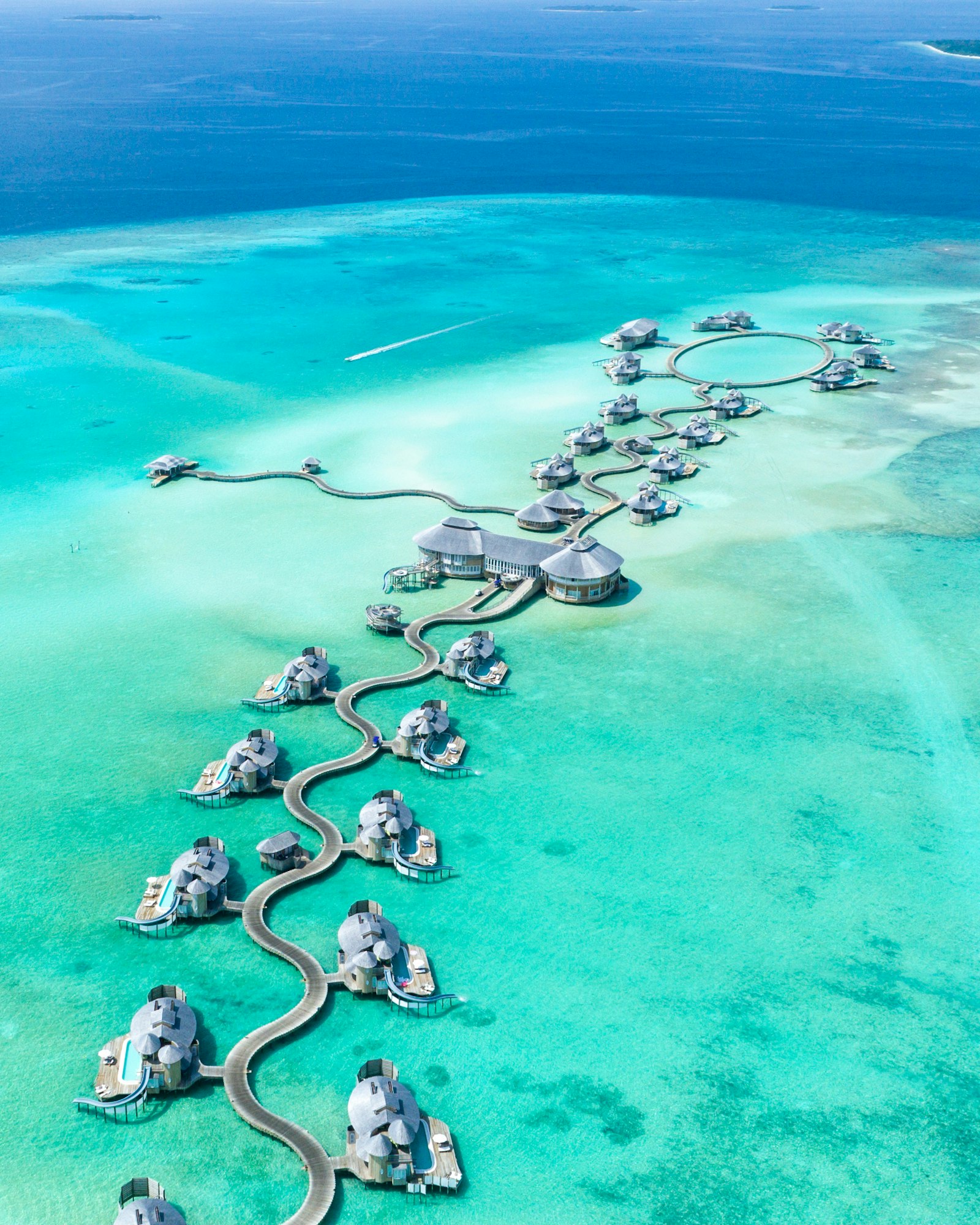 Overwater villas above a turquoise lagoon