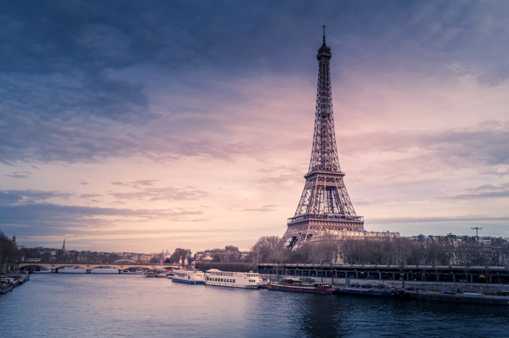 The Eiffel Tower above Parisian rooftops at dusk