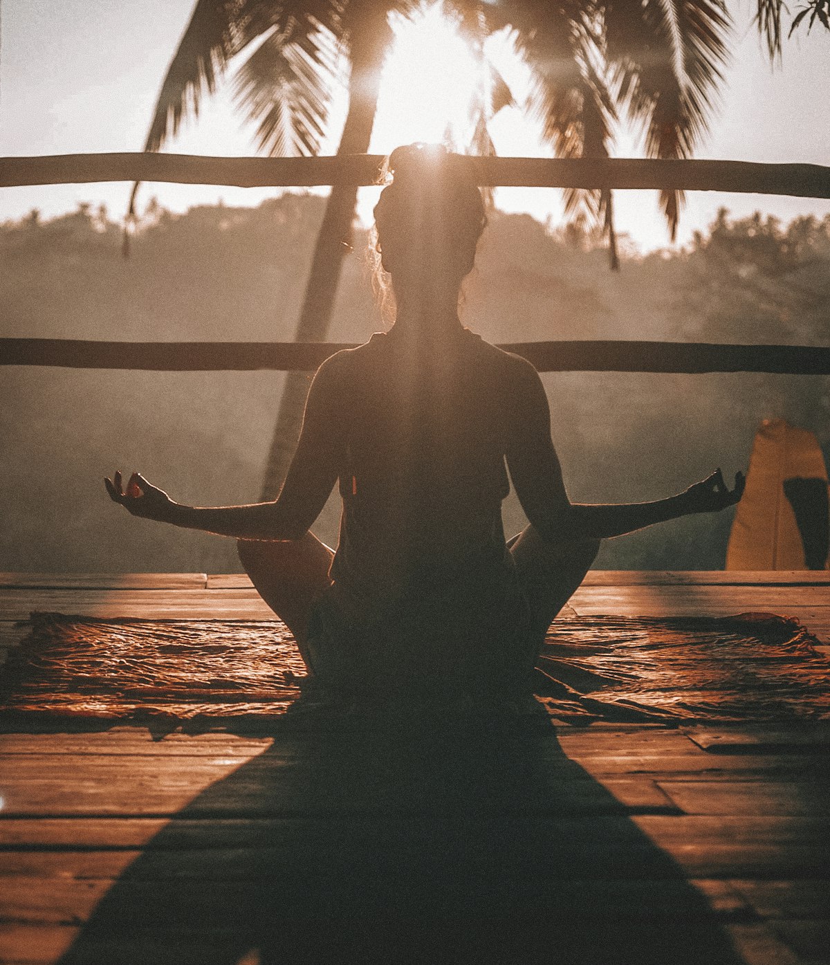 Sunrise yoga practice overlooking still water
